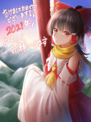  1girl 2021 ascot bow brown_hair commentary_request cure_musuka detached_sleeves frilled_bow frilled_hair_tubes frills hair_bow hair_tubes hakurei_reimu happy_new_year highres long_hair looking_at_viewer mountainous_horizon new_year outdoors red_bow red_eyes red_skirt ribbon-trimmed_sleeves ribbon_trim scarf skirt skirt_set solo torii touhou translation_request yellow_ascot yellow_scarf 