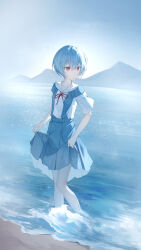  1girl absurdres ayanami_rei beach blue_hair blue_skirt chinese_commentary closed_mouth clothing_request commentary_request full_body highres looking_to_the_side mountain neon_genesis_evangelion ocean red_eyes red_ribbon ribbon shirt short_hair skirt sky solo standing suspenders wading water white_shirt z-bow 