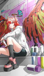  1girl absurdres arknights black_shoes black_shorts black_socks bright_pupils closed_mouth commentary dolphin_shorts drawn_halo drawn_wings fiammetta_(arknights) graffiti halo highres holding holding_spray_can hood hood_down hooded_jacket jacket kneehighs long_sleeves looking_at_viewer pink_shoes platform_shoes red_eyes red_hair shoes short_hair shorts sitting socks solo spray_can white_jacket white_pupils yagi000 