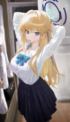  1girl absurdres alternate_breast_size_(larger) arms_behind_head arms_up black_skirt blonde_hair blue_archive blue_bow blue_bowtie blue_eyes blue_halo bow bowtie breasts chinese_commentary commentary_request hair_tie_in_mouth halo highres indoors jianjia large_breasts long_hair looking_at_viewer mouth_hold multicolored_hair official_alternate_costume pleated_skirt school_uniform shirt skirt solo streaked_hair toki_(blue_archive) toki_(school_uniform)_(blue_archive) two-tone_hair tying_hair white_shirt 