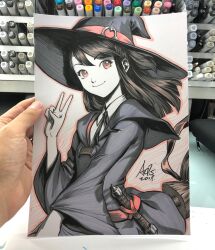  1girl art_tools_in_frame artist's_hand_in_frame broom broom_riding brown_eyes brown_hair closed_mouth commentary english_commentary hat highres kagari_atsuko little_witch_academia long_hair looking_at_viewer marker_(medium) photo_(medium) signature smile solo stanley_lau traditional_media upper_body v witch witch_hat 