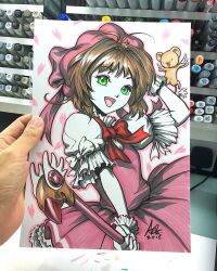 1girl art_tools_in_frame artist's_hand_in_frame bow cardcaptor_sakura commentary dress english_commentary fuuin_no_tsue gloves hat highres holding holding_wand kero_(cardcaptor_sakura) kinomoto_sakura kinomoto_sakura_(magician) magical_girl marker_(medium) photo_(medium) pink_dress pink_hat red_bow signature solo stanley_lau traditional_media wand white_gloves 