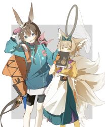  2girls absurdres amiya_(arknights) animal_charm animal_ear_fluff animal_ears apron arknights backpack bag bag_charm black_shorts blonde_hair blue_eyes blue_hairband blue_jacket book brown_hair butterfly_net charm_(object) feet_out_of_frame fingerless_gloves fox_ears fox_girl fox_tail gloves green_eyes hair_between_eyes hairband han_chi_zao_shui hand_net hand_up hands_up highres holding holding_book holding_butterfly_net hongshan_forest_zoo jacket kitsune long_hair long_sleeves looking_at_viewer multicolored_hair multiple_girls multiple_tails official_alternate_costume open_mouth orange_bag orange_gloves pink_gloves pink_scarf rabbit_ears rabbit_girl scarf shirt shorts simple_background smile standing suzuran_(arknights) tail white_apron white_background yellow_shirt 
