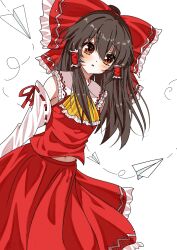  1girl ascot blush bow brown_eyes brown_hair commentary detached_sleeves frilled_bow frilled_hair_tubes frilled_skirt frills hair_bow hair_tubes hakurei_reimu hato_tototo long_hair looking_at_viewer paper_airplane red_bow red_skirt ribbon-trimmed_sleeves ribbon_trim simple_background skirt skirt_set solo touhou white_background yellow_ascot 