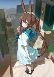  1girl absurdres alternate_costume amiya_(arknights) animal_ear_fluff animal_ears aqua_dress aqua_eyes aqua_sailor_collar arknights black_shoes brown_hair chinese_commentary closed_mouth commentary_request day dress extra_ears from_behind full_body hair_between_eyes hand_up highres long_hair looking_at_viewer looking_back nagisa_(cxcx5235) outdoors playing_with_own_hair rabbit_ears rabbit_girl sailor_collar shoes short_sleeves socks solo standing white_socks 