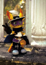  1girl :3 black_hat cape cat digimon digimon_(creature) extyrannomon eye_mask figure_(medium) green_eyes hat hat_feather highres looking_at_viewer mask nyabootmon outdoors photo_(medium) pillar purple_mask rapier smile solo sword v weapon whiskers 
