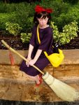  1girl broom cat caucasian cosplay ghibli kiki kiki&#039;s_delivery_service looking_down non-asian photo real_person sitting 