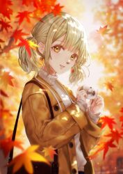  1girl autumn autumn_leaves avrcsl azusawa_kohane bag blonde_hair blue_pants blunt_bangs brown_bag brown_coat camera coat commentary_request dappled_sunlight earrings falling_leaves grey_sweater handbag highres holding holding_camera jewelry lanyard leaf leaf_print looking_at_viewer maple_leaf maple_leaf_print pants project_sekai revision sidelocks solo sunlight sweater twintails yellow_eyes 