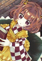  1girl :o apron bell black_eyes black_skirt book brown_hair checkered_clothes checkered_kimono clothes_writing commentary_request frilled_apron frills from_above hair_bell hair_ornament highres holding holding_book japanese_clothes katsuragi_atori kimono light_blush light_particles long_sleeves looking_at_viewer looking_up motoori_kosuzu parted_lips short_hair skirt solo standing touhou wide_sleeves wooden_floor yellow_apron 