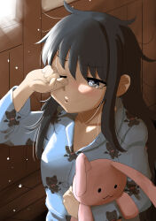  1girl alternate_costume animal_print asashio_(kancolle) black_hair blue_eyes blue_pajamas cat_print commentary_request highres kantai_collection messy_hair nekotarou_(nktr299) pajamas sleepy solo stuffed_animal stuffed_toy tears teddy_bear upper_body 