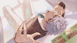  arurandeisu black_suit blue_eyes box box_of_chocolates chocolate commentary green_necktie grey_hair highres hikariemochi holostars looking_at_viewer lying necktie on_back pants short_hair suit table valentine white_pants 