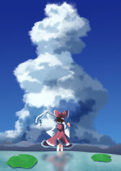  1girl absurdres blue_sky bow brown_hair clouds commentary_request day detached_sleeves frilled_bow frills gasubanana gohei hair_bow hakurei_reimu highres holding holding_gohei long_hair outdoors red_bow red_skirt reflection reflective_liquid ribbon-trimmed_sleeves ribbon_trim skirt skirt_set sky solo touhou water 