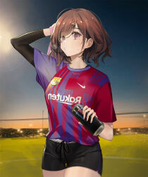  1girl breasts brown_hair can commentary cowboy_shot drawstring drink_can drive_shot fc_barcelona hair_ornament hairclip hand_on_own_head highres higuchi_madoka holding holding_can holding_towel idolmaster idolmaster_shiny_colors layered_sleeves long_sleeves looking_at_viewer medium_breasts mole mole_under_eye monster_energy outdoors parallel_hairclips parted_lips short_hair short_over_long_sleeves short_shorts short_sleeves shorts sky soccer_uniform solo sportswear standing sweat towel violet_eyes 