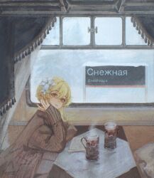 1girl blonde_hair brown_coat closed_mouth coat cup curtains cyrillic flower genshin_impact hair_between_eyes hair_flower hair_ornament hand_on_own_cheek hand_on_own_face highres looking_at_viewer lumine_(genshin_impact) medium_hair rumpumpel_x russian_text sitting snow solo table tablecloth train_interior train_station white_flower yellow_eyes