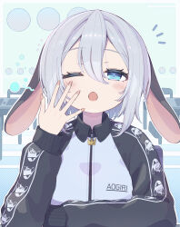  1girl absurdres animal_ears aogiri_koukou blue_eyes blush commentary_request double-parted_bangs fingernails floppy_ears gorirasaru440 grey_hair grey_jacket hair_between_eyes hand_up highres jacket looking_at_viewer lop_rabbit_ears official_alternate_costume one_eye_closed open_mouth rabbit_ears raglan_sleeves ringed_eyes short_hair solo track_jacket upper_body virtual_youtuber yamaguro_nekuro yawning zipper 