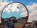  chainlink_fence cloud clouds doraemon doraemon_(character) flying highres house mirror motor_vehicle no_humans reflection ryoun sky street traffic_mirror vehicle 