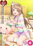  1girl blush brown_hair card_(medium) character_name hair_bow happy hoodie long_hair love_live!_school_idol_project minami_kotori official_art open_mouth pillow shorts side_ponytail smile solo stuffed_animal yellow_eyes 